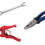 Hand tools for plumbing, including a silver wrench, red clamp, and blue pliers, ready for repairs by Hancock & Son.